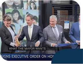 Officials sign executive order at press event.