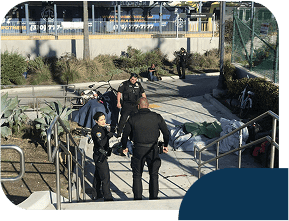 Police officers interacting with people in urban area.
