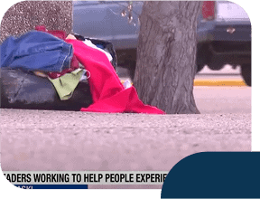 Clothes placed on sidewalk near tree and street