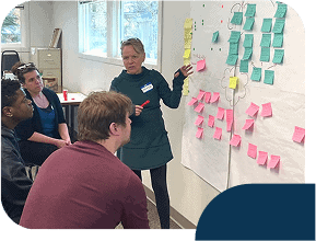 Team brainstorming with sticky notes on board