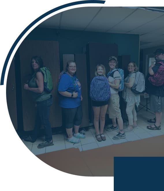 Group standing with backpacks indoors