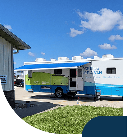 Mobile healthcare van parked outside building
