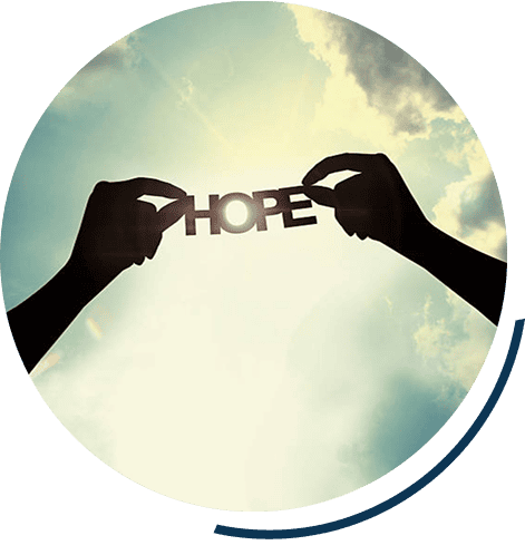 Silhouette holding 'Hope' against sky