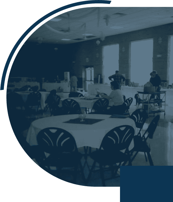 People setting up tables in event hall