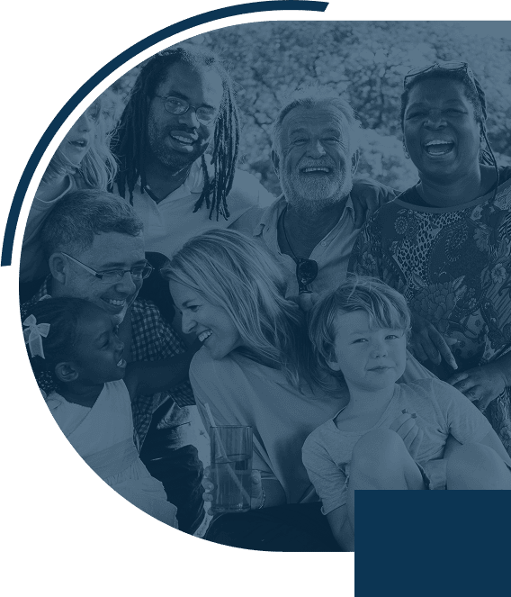 Diverse group of people smiling together outdoors.