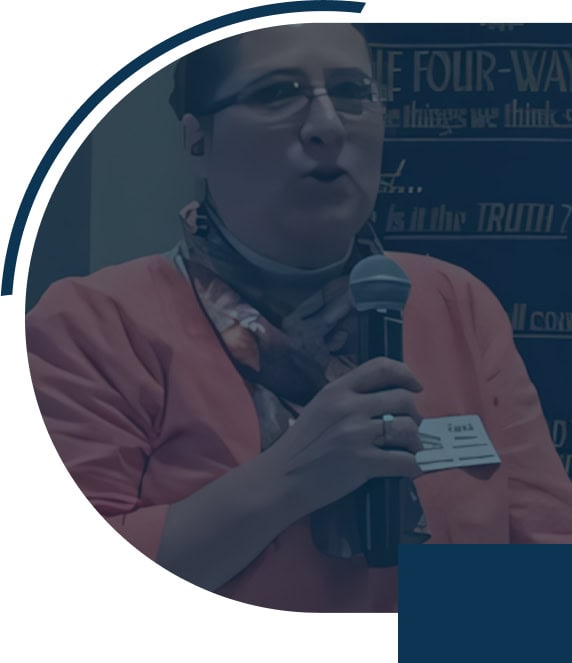 Person speaking into a microphone at event.