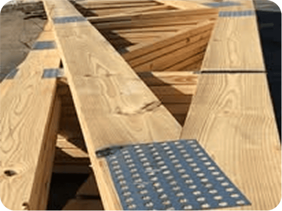Wooden roof trusses with metal plates outdoors